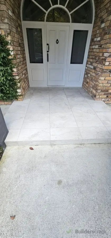 Light grey large format porcelain tiles on a residential entrance porch installed by Dakom Tiling Auckland