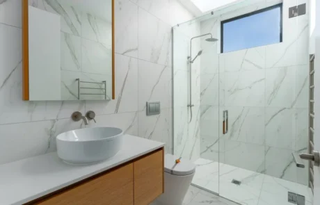 Modern bathroom tiling with marble look tiles walk in shower and clean professional finish Dakom Tiling Auckland